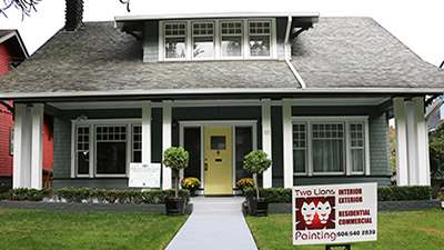 House exterior with painting service sign